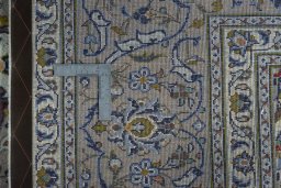 Backside of handmade 2000s Kashan rug showing knot structure and weave density
