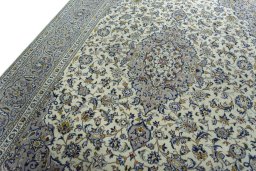 Backside of handmade 2000s Kashan rug showing knot structure and weave density