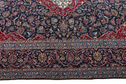 Corner detail of 2000s Kashan rug showing border pattern and Wool pile