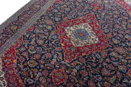 Backside of handmade 2000s Kashan rug showing knot structure and weave density
