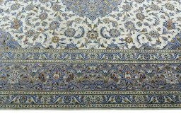 Corner detail of 2000s Kashan rug showing border pattern and Wool pile