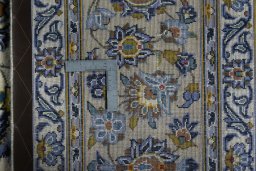 Backside of handmade 2000s Kashan rug showing knot structure and weave density