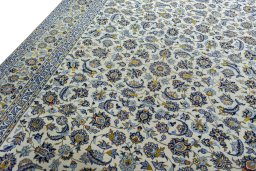 Backside of handmade 2000s Kashan rug showing knot structure and weave density
