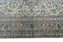 Corner detail of 2000s Kashan rug showing border pattern and Wool pile