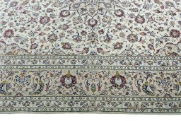 Corner detail of 2000s Kashan rug showing border pattern and Wool pile