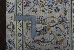 Backside of handmade 2000s Kashan rug showing knot structure and weave density