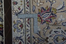 Backside of handmade 2000s Kashan rug showing knot structure and weave density