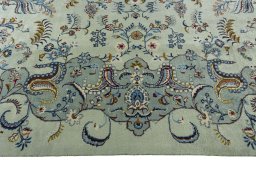 Corner detail of 2000s Kashan rug showing border pattern and Wool pile