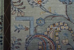 Backside of handmade 2000s Kashan rug showing knot structure and weave density