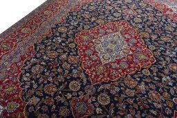 Backside of handmade 2000s Kashan rug showing knot structure and weave density