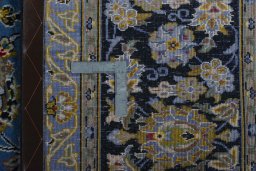 Backside of handmade 2000s Kashan rug showing knot structure and weave density