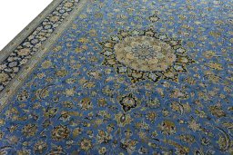Backside of handmade 2000s Kashan rug showing knot structure and weave density