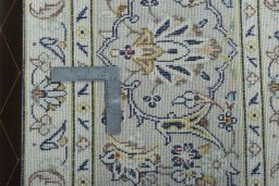 Backside of handmade 2000s Kashan rug showing knot structure and weave density