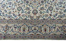 Corner detail of 2000s Kashan rug showing border pattern and Wool pile