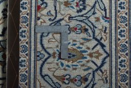 Backside of handmade 2000s Kashan rug showing knot structure and weave density