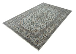 Corner detail of 2000s Kashan rug showing border pattern and Wool pile