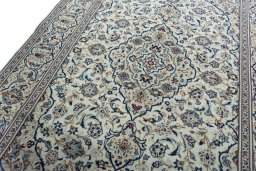 Backside of handmade 2000s Kashan rug showing knot structure and weave density