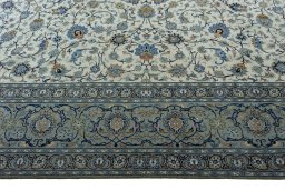 Corner detail of 2000s Kashan rug showing border pattern and Wool pile