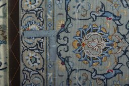 Backside of handmade 2000s Kashan rug showing knot structure and weave density