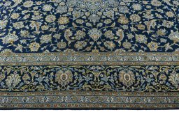 Corner detail of 2000s Kashan rug showing border pattern and Wool pile