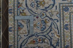 Backside of handmade 2000s Kashan rug showing knot structure and weave density