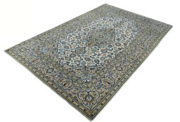 Corner detail of 2000s Kashan rug showing border pattern and Wool pile