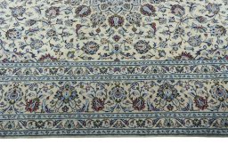 Corner detail of 2000s Kashan rug showing border pattern and Wool pile