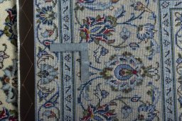 Backside of handmade 2000s Kashan rug showing knot structure and weave density
