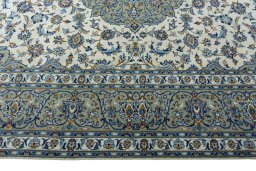 Corner detail of 2000s Kashan rug showing border pattern and Wool pile