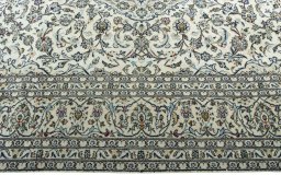 Corner detail of 2000s Kashan rug showing border pattern and Wool pile