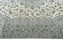 Corner detail of 2000s Kashan rug showing border pattern and Wool pile