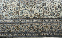 Corner detail of 2000s Kashan rug showing border pattern and Wool pile
