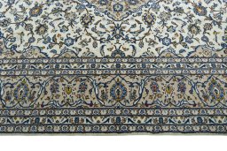 Corner detail of 2000s Kashan rug showing border pattern and Wool pile
