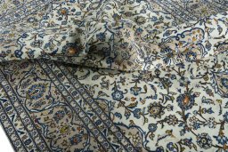 Surface texture of 2000s Kashan rug with natural Wool and intricate pattern