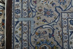 Backside of handmade 2000s Kashan rug showing knot structure and weave density