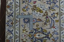 Backside of handmade 2000s Kashan rug showing knot structure and weave density