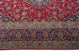 Corner detail of 2000s Kashan rug showing border pattern and Wool pile