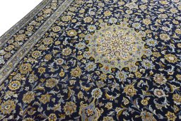 Backside of handmade 2000s Kashan rug showing knot structure and weave density