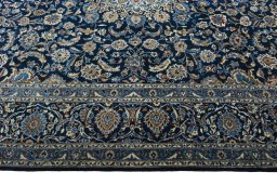 Corner detail of 2000s Kashan rug showing border pattern and Wool pile