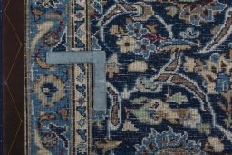 Backside of handmade 2000s Kashan rug showing knot structure and weave density