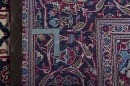 Backside of handmade 2000s Kashan rug showing knot structure and weave density