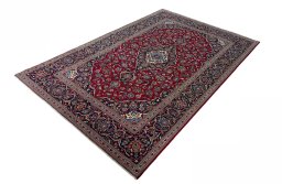 Corner detail of 2000s Kashan rug showing border pattern and Wool pile