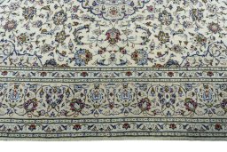 Corner detail of 2000s Kashan rug showing border pattern and Wool pile
