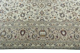 Corner detail of 2000s Kashan rug showing border pattern and Wool pile