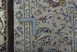 Backside of handmade 2000s Kashan rug showing knot structure and weave density