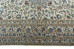 Corner detail of 2000s Kashan rug showing border pattern and Wool pile