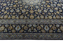 Corner detail of 2000s Kashan rug showing border pattern and Wool pile