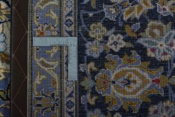 Backside of handmade 2000s Kashan rug showing knot structure and weave density