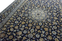 Backside of handmade 2000s Kashan rug showing knot structure and weave density