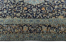 Corner detail of 2000s Kashan rug showing border pattern and Wool pile